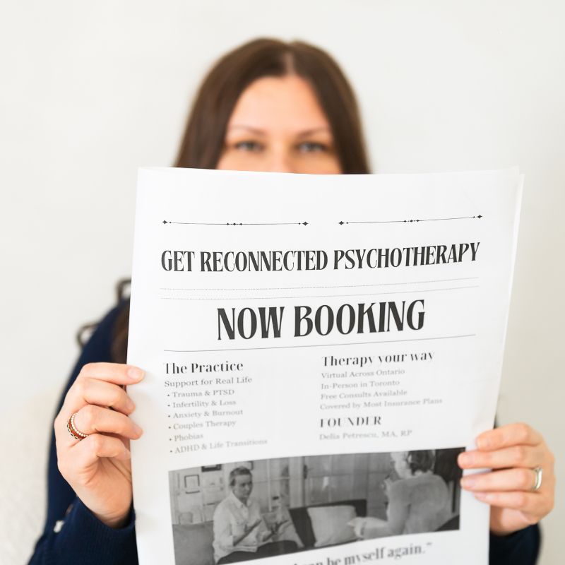 Delia Petrescu holding a Get Reconnected newspaper