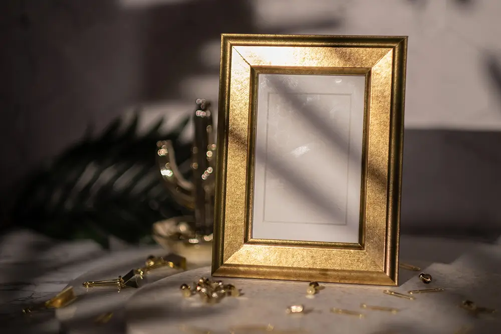 Stylish emptu golden frame mockup positioned on a marble table