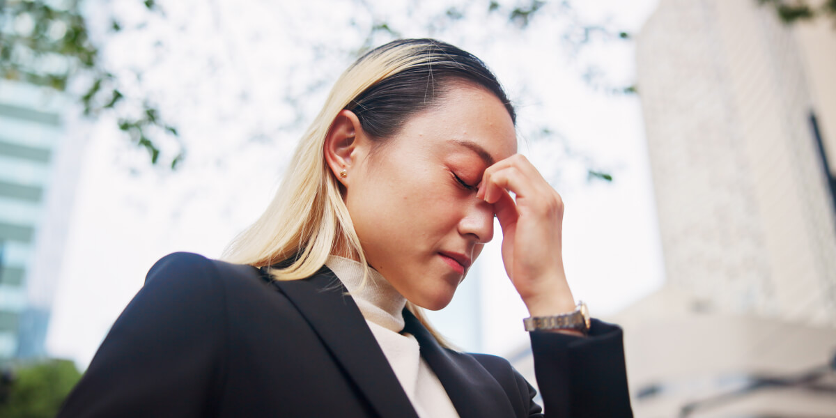 Asian woman, headache or strain with stress in city for company debt, bankruptcy or fail. Frustrate.